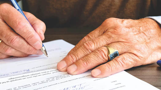 A business owner signing a document 