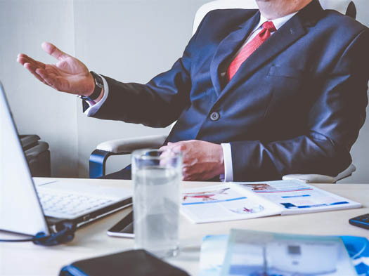 Man in suit engaged in company sale negotiation