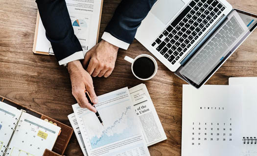 Business executive pointing to documents on a desk 