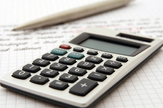 Calculator on top of grid paper with tax calculations