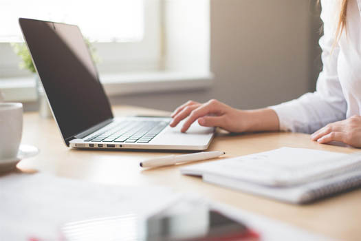 Woman using a laptop for a customer survey