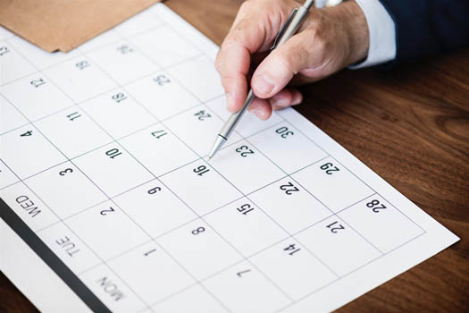 A calendar on a table for planning year end maximizations
