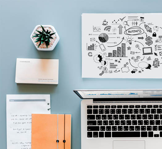 Desk with laptop and documents with annual report charts