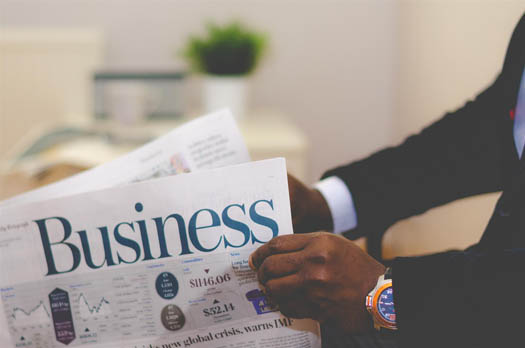 A business man reading a newspaper 