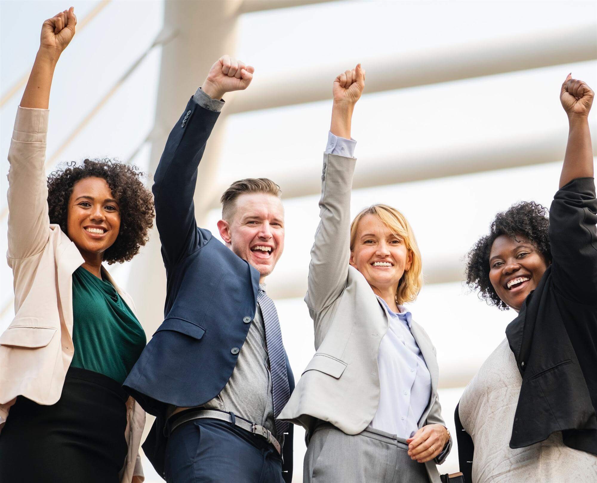 Business people celebrating with fists in the air